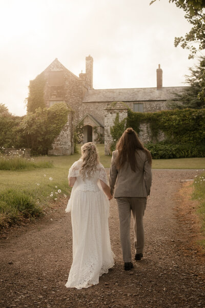 Wedding couple golding hands at Ash Barton Estate