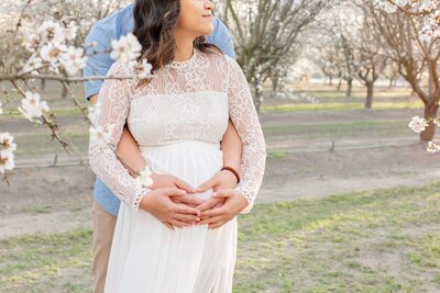 Bride and Groom hugging while holding hands in a beautiful garden