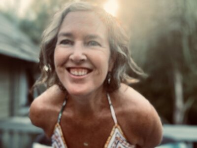 Portrait of Laura Kate surrounded by soft light, representing intuition, spiritual clarity, and subconscious healing work
