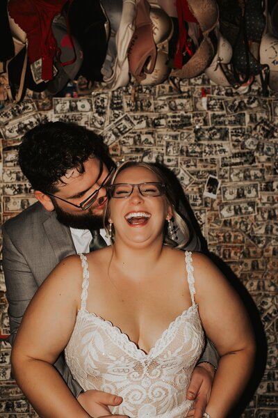 Couple in front of the dollar bill wall at Captain Tony's in Key West 