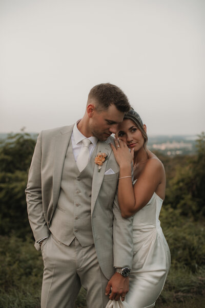 wedding couple hugging by the water