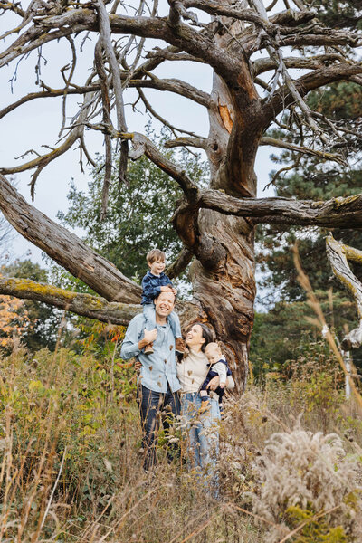 Family posing by giant tree in High Park