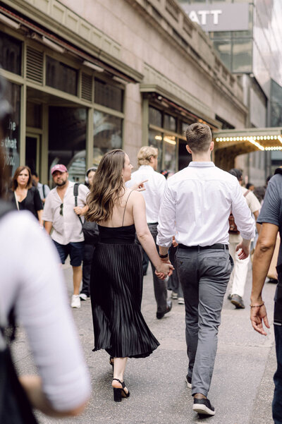 Michelle and Dean walking through NYC during their stylish engagement session, captured with cinematic editorial photography.