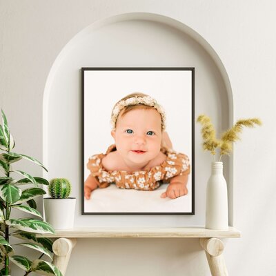framed photo of little girl in floral during Springfield Mo baby milestone sessionmed newborn photo in Springfield MO of living room