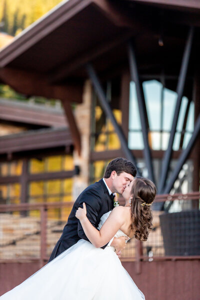 bride and groom kissing in front of Vail Mountain the Tenth Wedding Venue