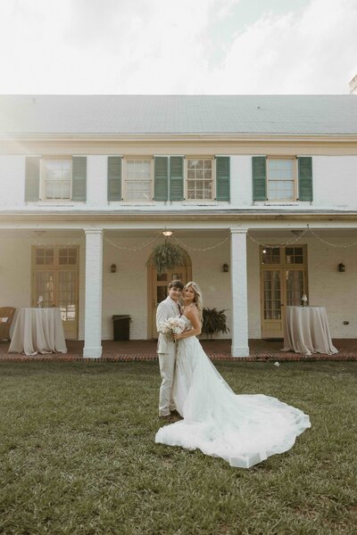 Bride and groom stand at their ceremony location overlooking the water in Switzerland, Florida.