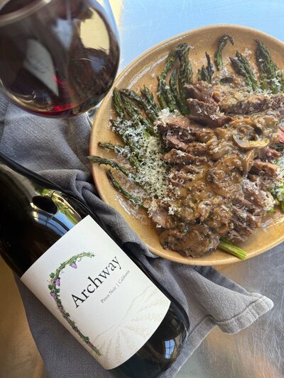 Ribeye, asparagus, and mushroom dinner with pinot noir wine