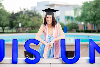 close up of SLU senior smiling in front of the SLU fountain