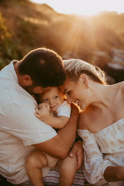 Father and mother holding baby in Sydney outdoor family photography session