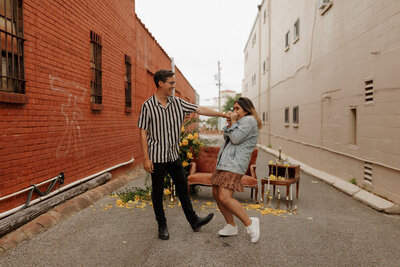 outdoor proposal with elaborate setup with a couch and florals in downtown pensacola