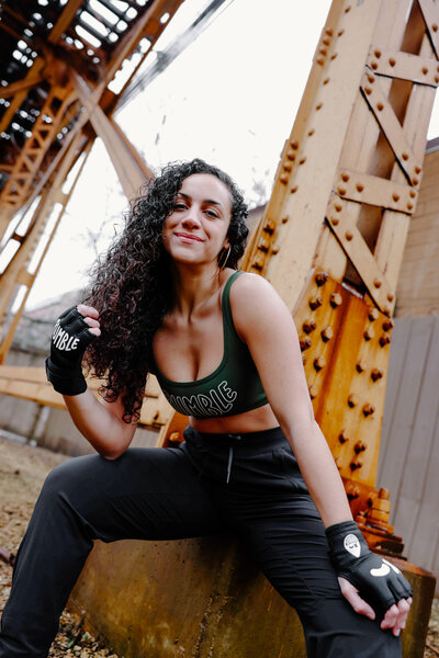 Rumble boxing teacher, Teresa Williams, poses under a bridge