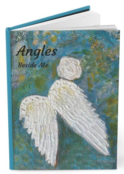 Painting of white feather on a blue canvas hardcover journal