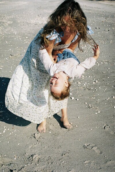 Mom holding and playing with her kid taken by east coast photographer Shelby Ann Photos