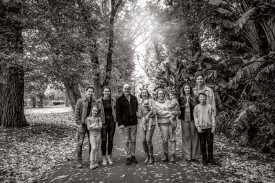 Black and white extended family portrait taken in an inner city Melbourne park