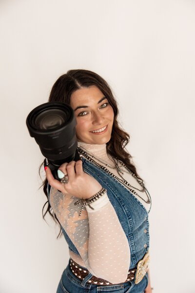 Southwest Missouri photographer holding up her camera