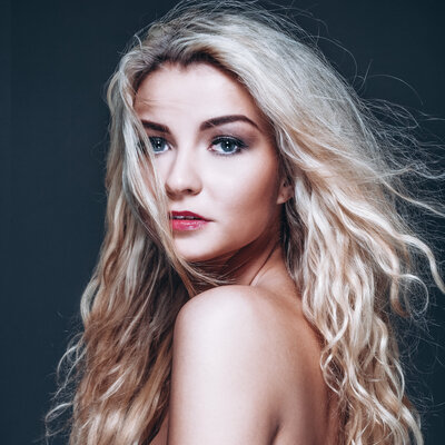 woman with blue eyes and long wavy blond hair