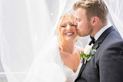 Milwaukee wedding photo of couple under veil at jan serr studio in downtown