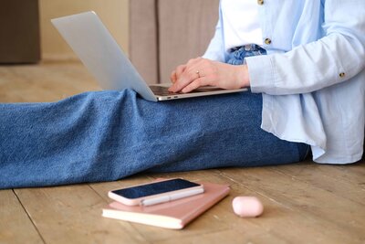 a-young-woman-sitting-on-the-floor-with-a-laptop-2025-02-10-06-07-00-utc