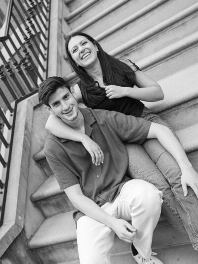 Couple sitting on steps on Baltimore laughing, taken by one of the best baltimore wedding photographers Nicole Simensky