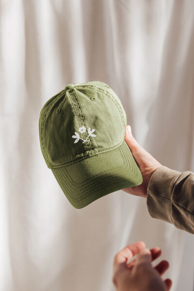 a green hat with a floral design