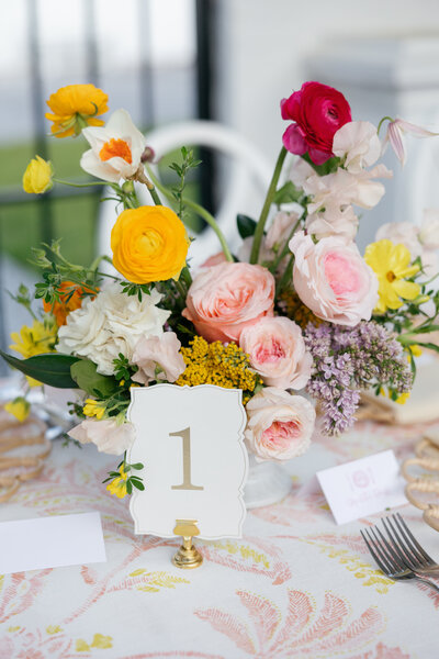 Wicker basket centerpieces with cream and orange florals