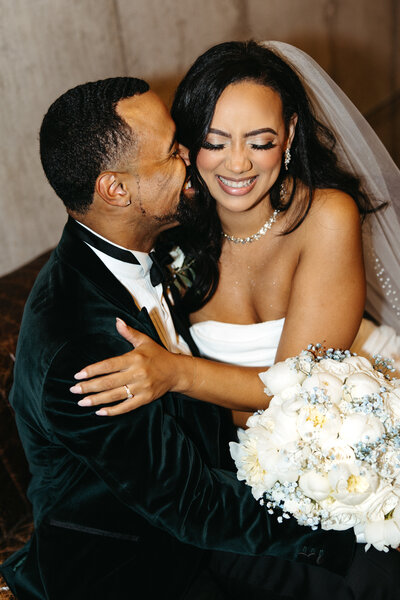 Wedding couple kissing at their arkansas wedding venue Barn at the springs.