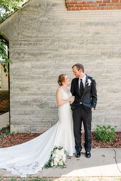 Couple standing outside of deer creek manor, Bloomington, Indiana.