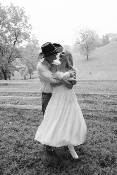 Black and white image of woman and man in cowboy hat during Nashville engagement session