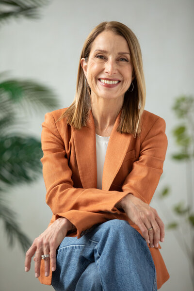 A confident woman, smiling, and conveying poise and professionalism