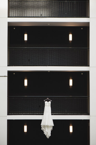 A wedding dress hanging off of a balcony 