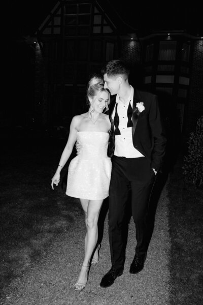 photograph of a bride and groom in a field at iscoyd park laughing. a natural wedding photo
