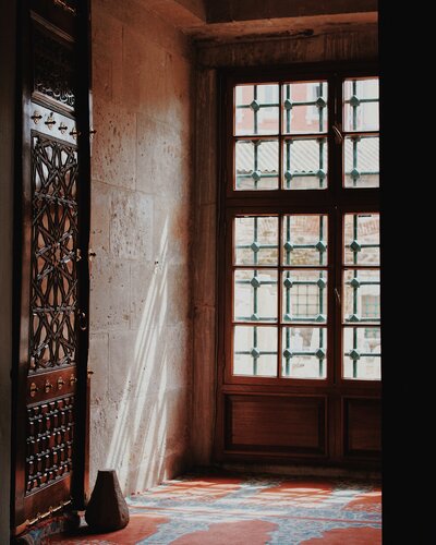 shadowed moroccan doorway with bright tiled floors and stone walls