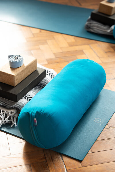 Mat and bolster in yoga studio