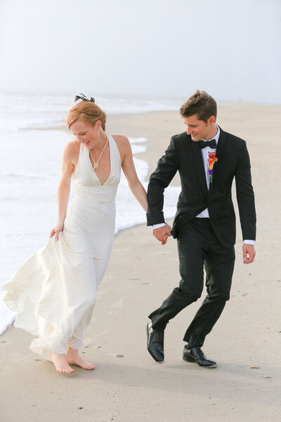 "Bride and groom playing in the surf on Bald Head Island"