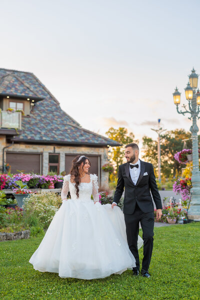 Bride and groom walking while looking at each other