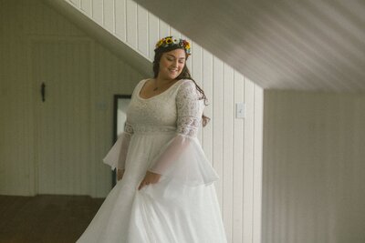 boho bride twirls her dress in an attic room
