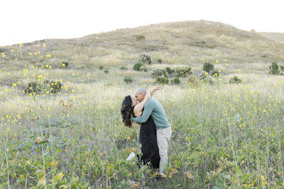 romantic couple kissing in open field