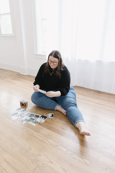 wedding photographer looking through printed images