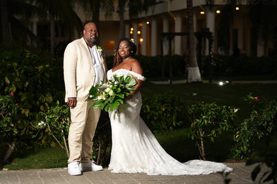 A couple enjoys their destination wedding in Puerto Plata, Puerto Rico, while a photographer captures the special moments.