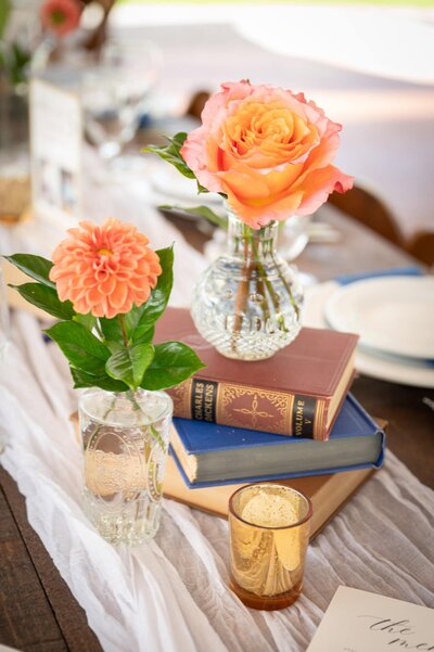 book centerpiece with two orange flowers