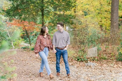 Engaged couple walking through nature preserve | Alabama wedding photographer Amanda Horne