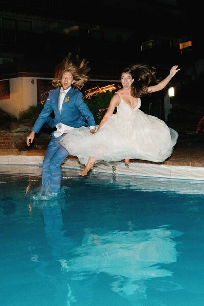 Bride and groom jump into pool at stowehof in vermont planned by lindsey leighthammer events