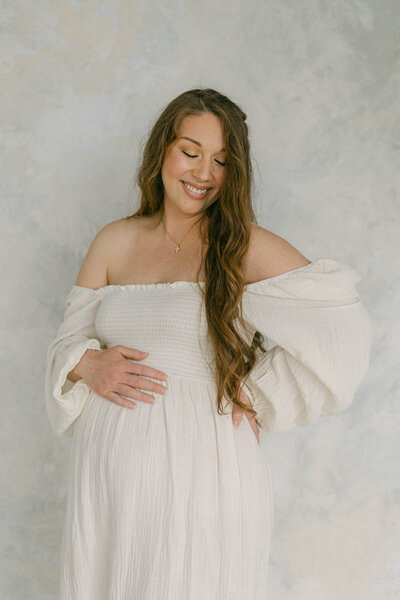 pregnant women holding belly and smiling  knoxville tennessee newborn photographer