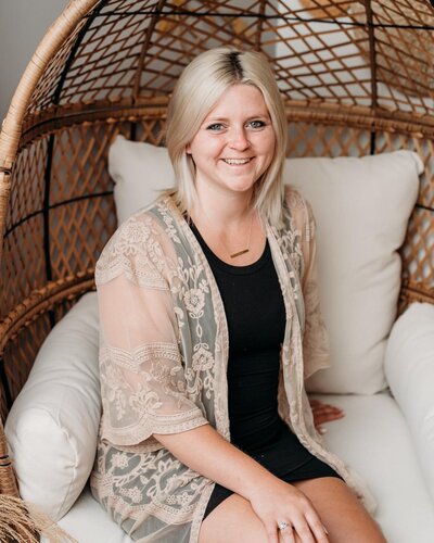 jaclyn sitting on a chair with pillows