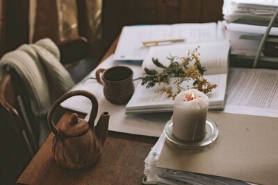 A cozy mountain home with candles and papers arranged on the table.