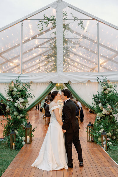 A couple sharing a kiss at wedding reception in Brooklyn, Connecticut