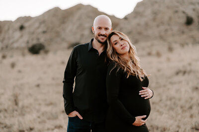 maternity couple wearing black