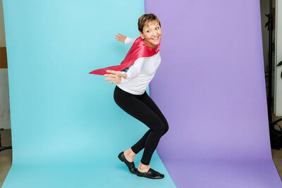 Melinda Fornero in a superhero cape dancing