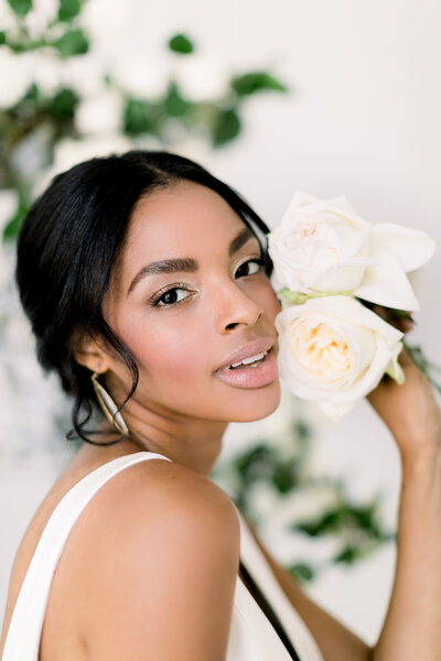Diverse bride with her white wedding flowers