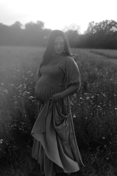 black and white maternity photos in a field